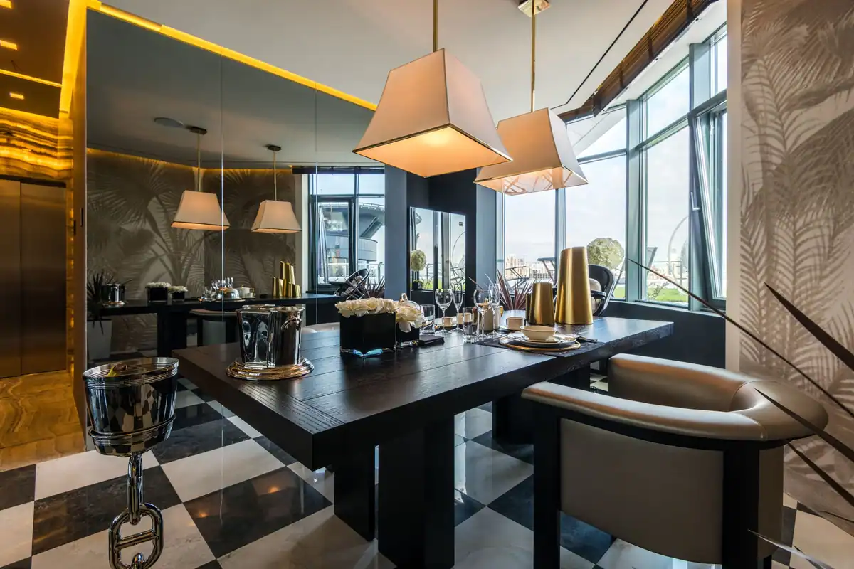 Sufragerie cu lămpi suspendate și ferestre mari spre oraș